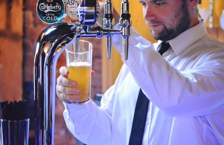 Bar staff pouring a pint of cider
