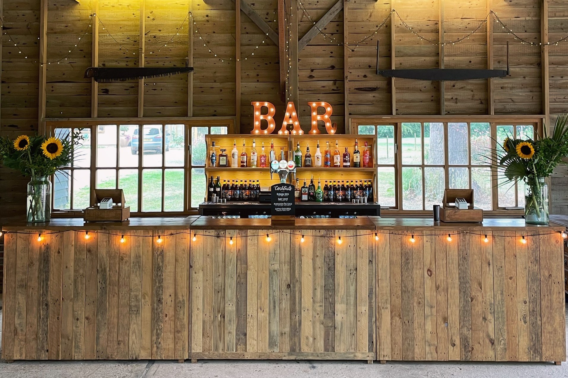 Wooden bar units made from reclaimed pallets with festoon lighting