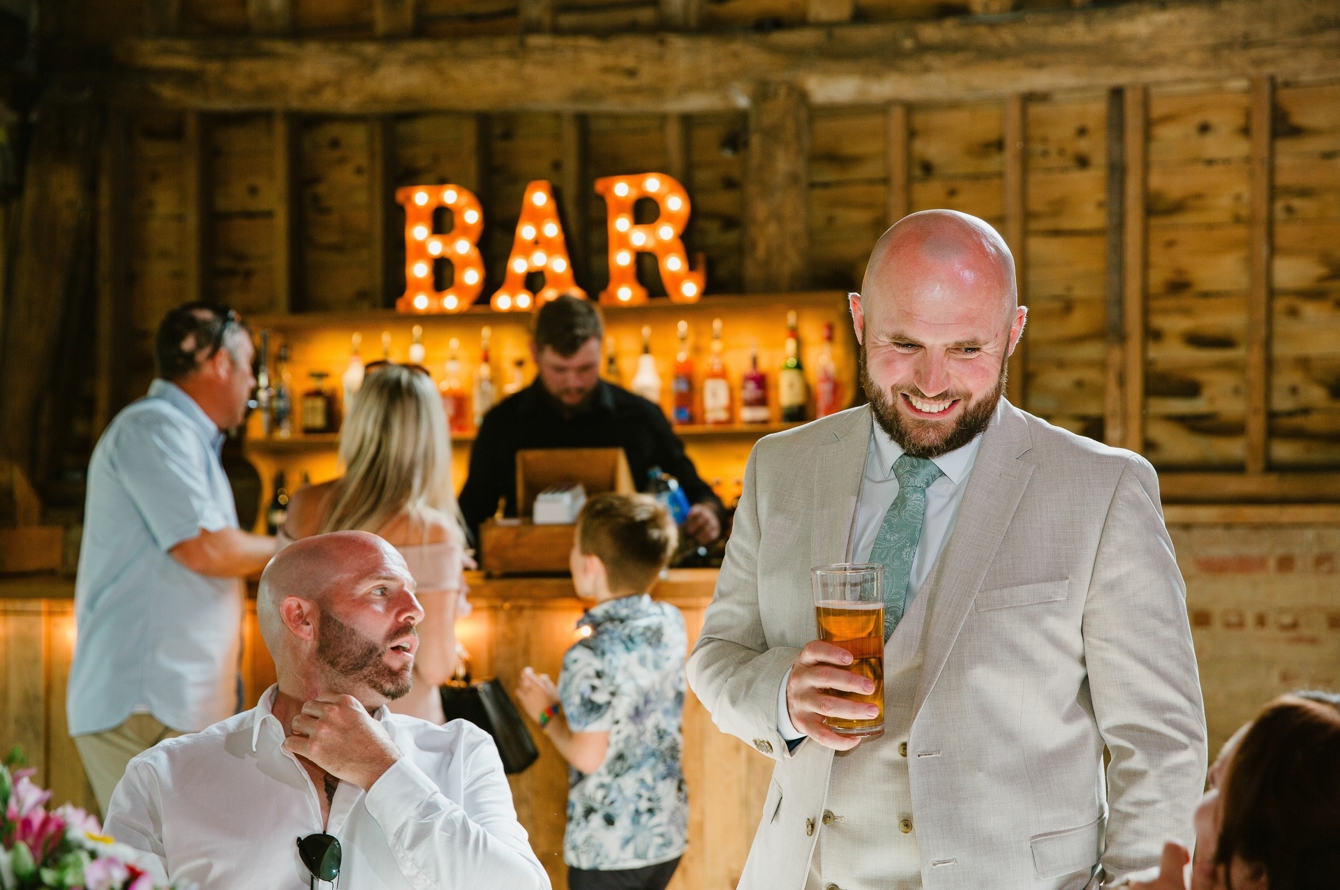 Groomsmen having a drink before speeches at a wedding in Colchester