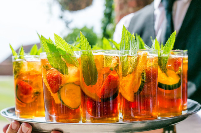 A tray of Pimms and lemonade being carried by waiting staff